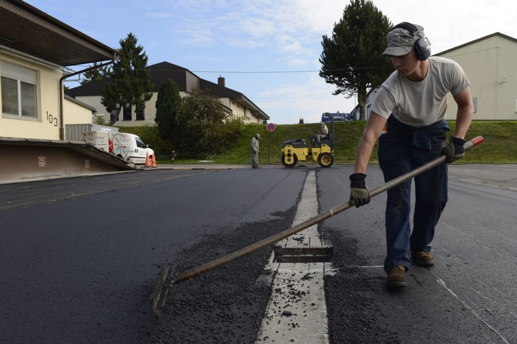 man fixing asphalt